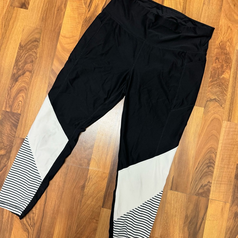 Used condition black leggings dri fit with white detail on leg, large